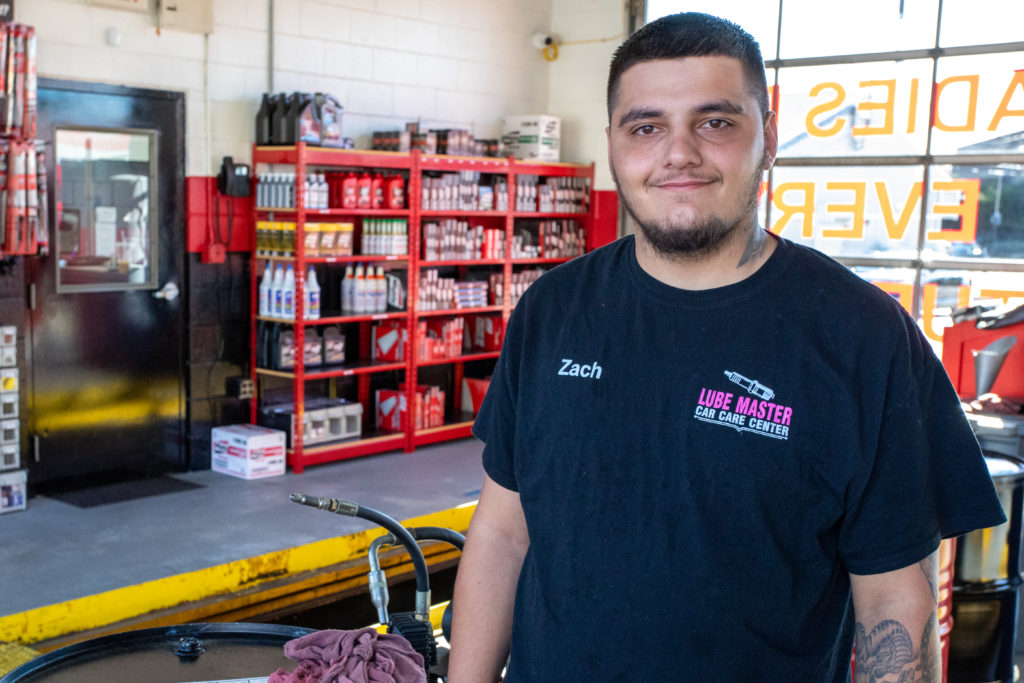 Zach from Lube Master standing inside a service garage.
