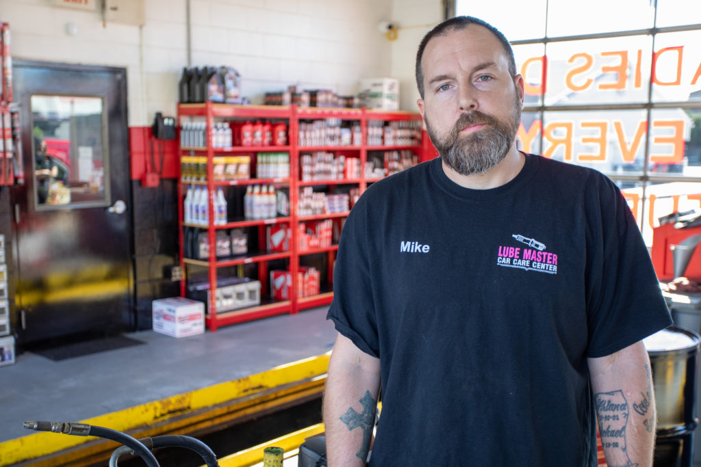 Mike from Lube Master standing inside a service garage.